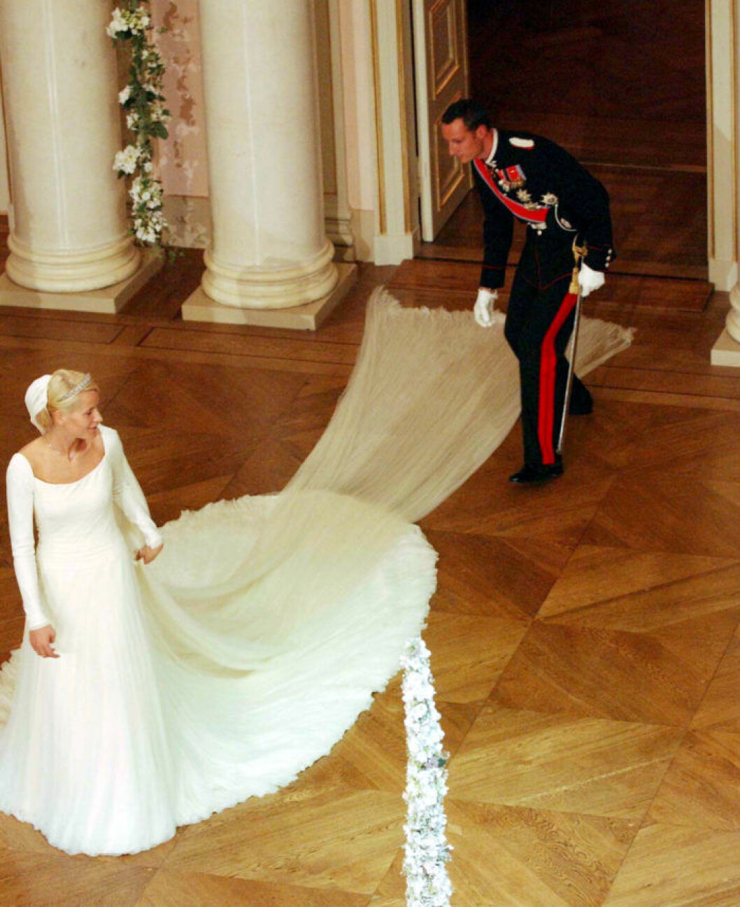 PRINCE HAAKON MAGNUS AND NEW WIFE METTE MARIT TJESSEM HOIBY (HAAKON RELEASING METTE MARIT'S DRESS AFTER IT GOT STUCK IN THE DOOR)