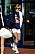 Diana i sweatshirt med reklamtryck på efter att ha spelat tennis, hon har vita tajta cykelbyxor, vita sportiga strumpor och chunky sneakers i vitt och svart. Hon har solglasögon på sig.
