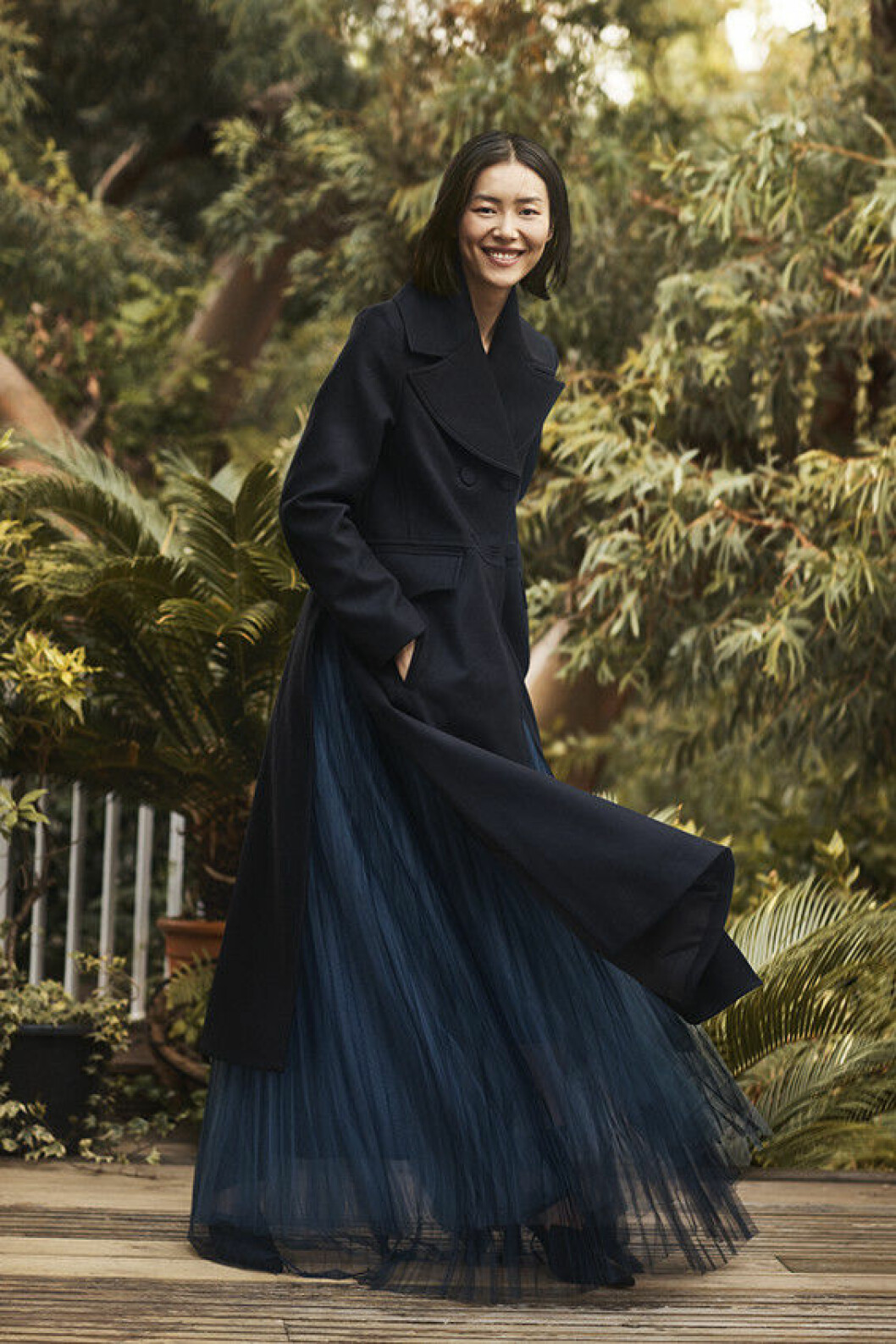 Lång, svart höstkappa i ullmix och axelbandslös, mörkblå långklänning i återvunnen polyester. H&M Conscious Exclusive-kollektionen för höst/vinter 2018