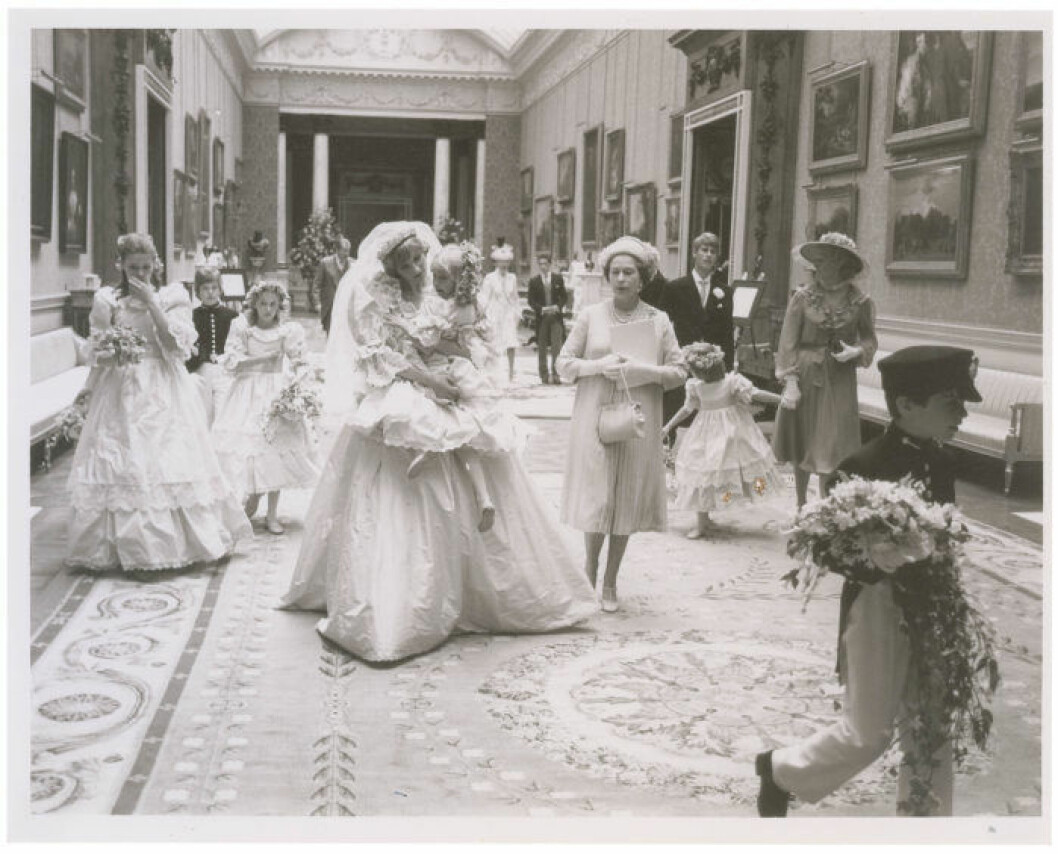 A collection of 12 unpublished behind the scenes photographs from the wedding of Princess Diana and Prince Charles are set to sell for *** when they go under the hammer. The pictures were taken at their reception at Buckingham Palace on July 29 1981 after their wedding ceremony at St. Paul's Cathedral. They originate from the collection of a an assistant to photographer Patrick Lichfield and include seven black and white pictures and five color, as well as the assistant's access pass to the palace. Six of the larger photos depict Princess Diana wearing her gorgeous wedding dress with members of her family and wedding party, including Queen Elizabeth, Prince Charles, Princess Ann, Princess Margaret, and Prince Andrew. Three show Princess Diana holding the five-year-old Clementine Hambro, her youngest bridesmaid; one shows her setting Clementine down; and another shows her smiling as Prince Andrew leans over to talk to Clementine. Queen Elizabeth is clearly visible walking alongside Princess Diana in four of the images, and the Queen Mother is seen in two. Prince Charles is also in two of these photographs. The last of the photos is the most striking of all, depicting Princess Diana and Prince Charles from behind on the famous balcony overlooking the massive crowds gathered on the Mall in front of Buckingham Palace. The lot will be sold by RR Auction in Cambridge, MA, on September 24 2015. Ref: SPL1098968 100815 Picture by: RR Auction / Splash News Splash News and Pictures Los Angeles: 310-821-2666 New York: 212-619-2666 London: 870-934-2666 photodesk@splashnews.com