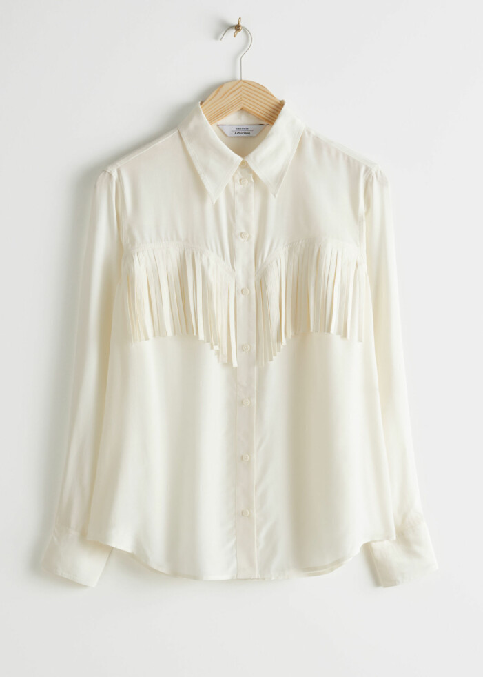 Vit blus med fransar