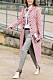 Dotted coat on a woman. Street fashion photo
