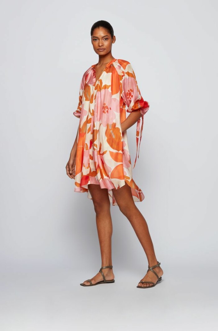 Klänning, 4 399 kr, Hugo Boss. Klänning i vid modell med blommönster i rosa, rött och orange. Klänningen är plåtad på modell. Klänning från Hugo Boss.