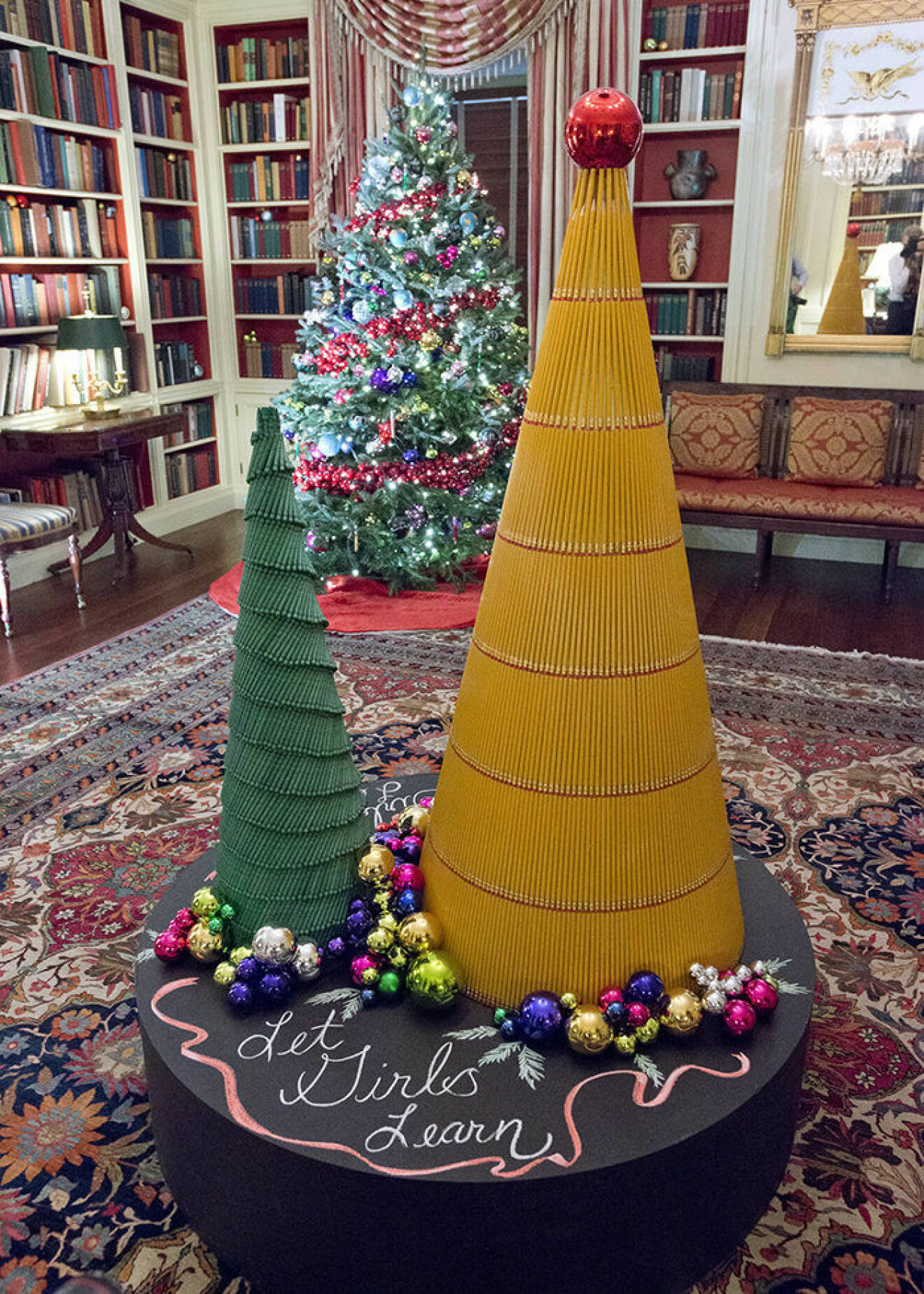 The 2016 White House Christmas decorations are previewed for the press at the White House in Washington, DC on Tuesday, November 29, 2016. The Gift of Education is brought to life in The Library, highlighting the more than 2,700 books housed there. Rulers will rim the base of the holiday trees while crayons and pencils create additional standalone trees. The colorful ornaments on display will spell out the word ?girls? in 12 different languages, paying homage to the First Lady?s Let Girls Learn initiative. The first lady's office released the following statement to describe those decorations, "This year?s holiday theme, 'The Gift of the Holidays,' reflects on not only the joy of giving and receiving, but also the true gifts of life, such as service, friends and family, education, and good health, as we celebrate the holiday season." Credit: Ron Sachs / CNP - NO WIRE SERVICE - Photo: Ron Sachs/Consolidated/dpa (c) DPA / IBL BildbyrÂ