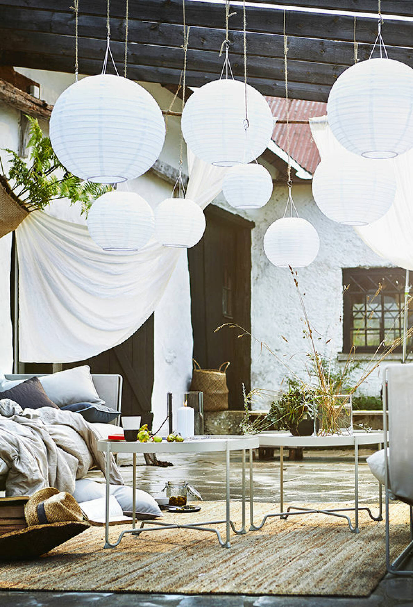 Cosy outdoor space with furniture and lamps in the ceiling.
