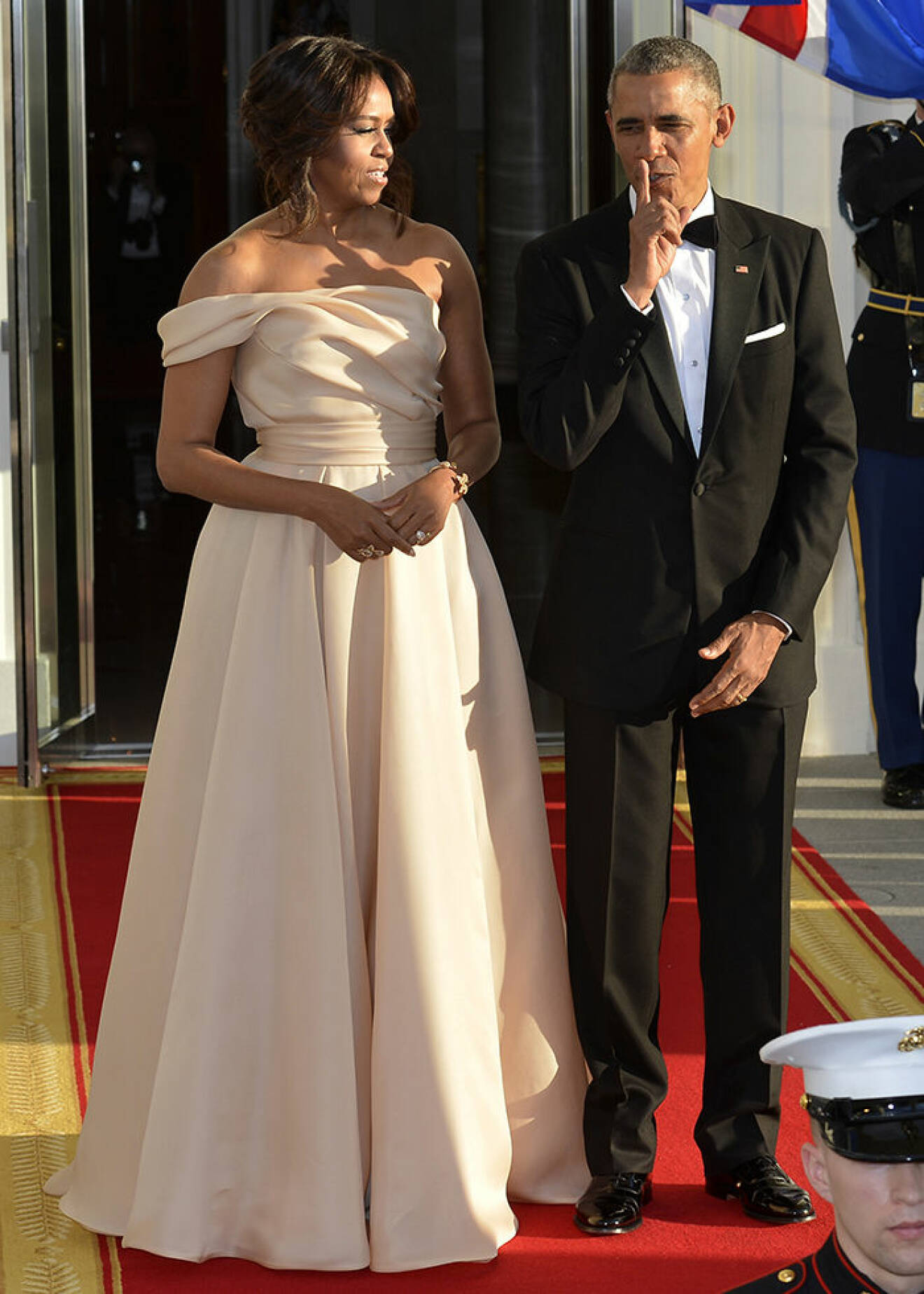 U.S. President Barack Obama gestures a whisper as he and First Lady Michelle Obama await the arrival of leaders from the five Nordic countries for a State Dinner WEARING NAEEM KHAN
