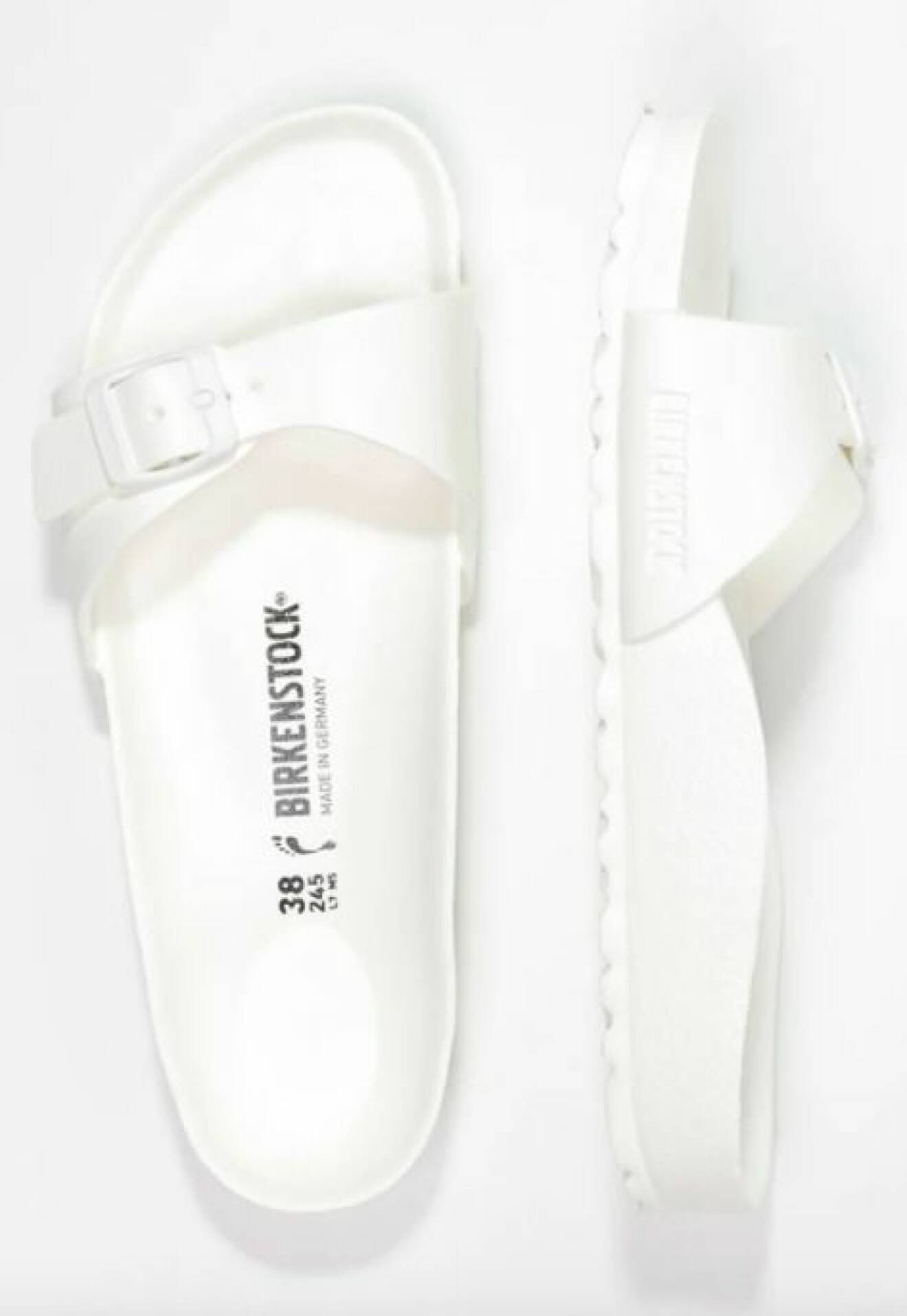 Vita sandaler med en rem i plast. Badsandaler från Birkenstock.
