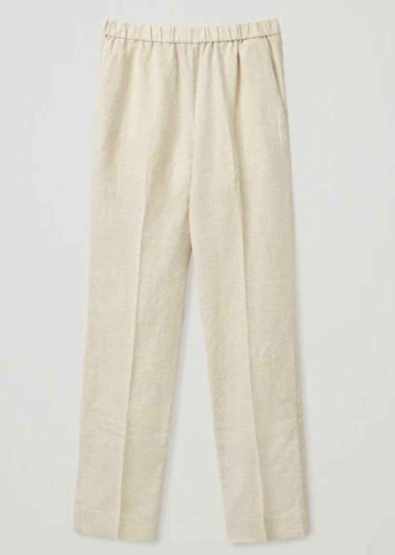 Off-white, beiga byxor med pressveck i linne från Cos.