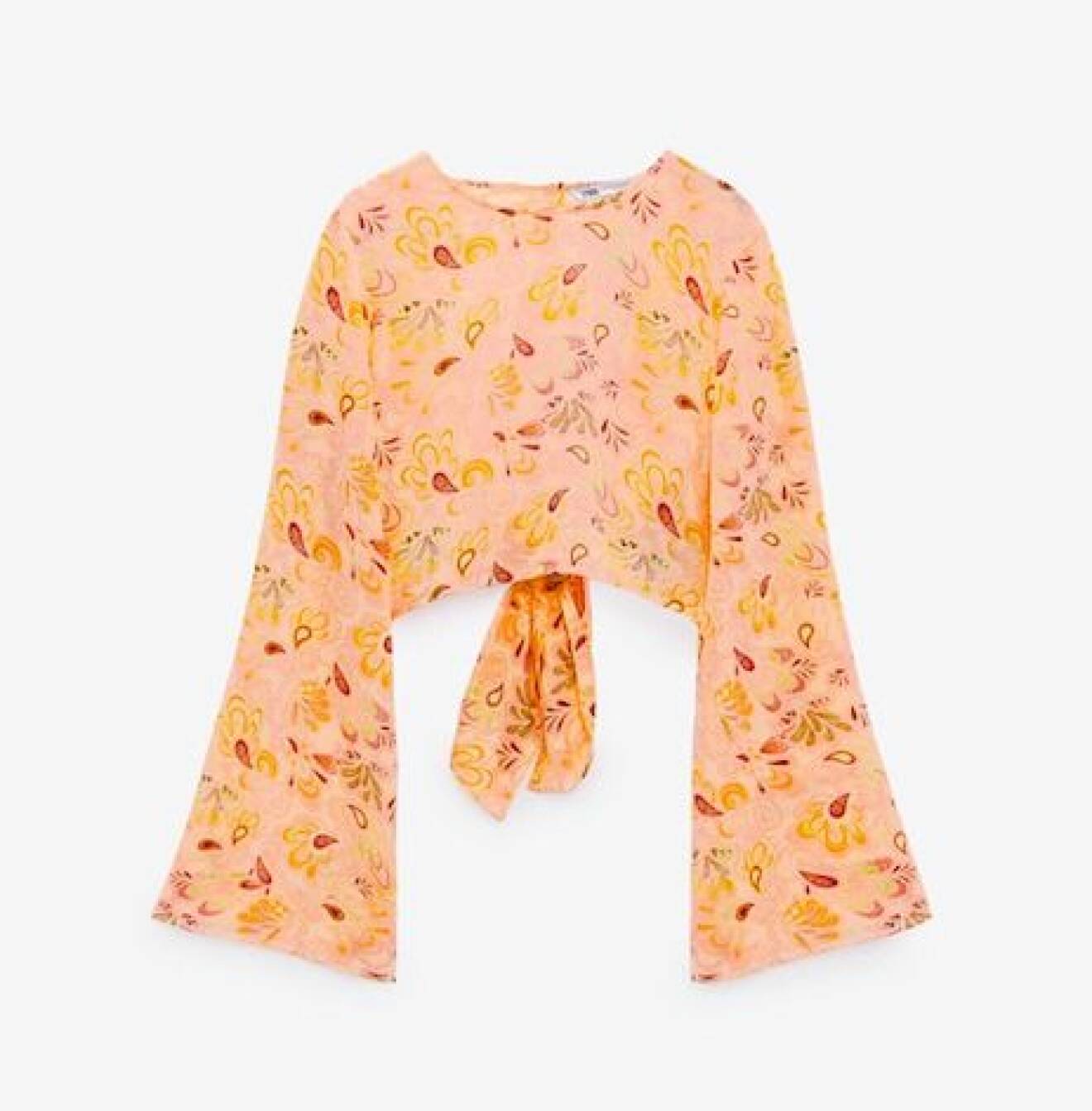 Rosa croppad tröja med långa ärmar och bar rygg med knytdetalj i bak. Mönster i gult, rött och orange. Topp från Zara.