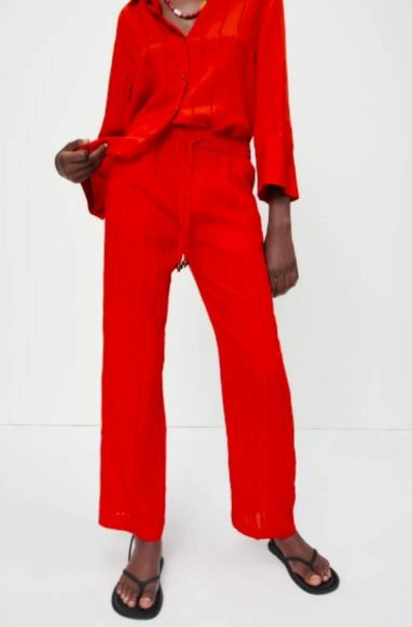 Röda, raka byxor med struktur och resår i midjan. Byxor från Zara.