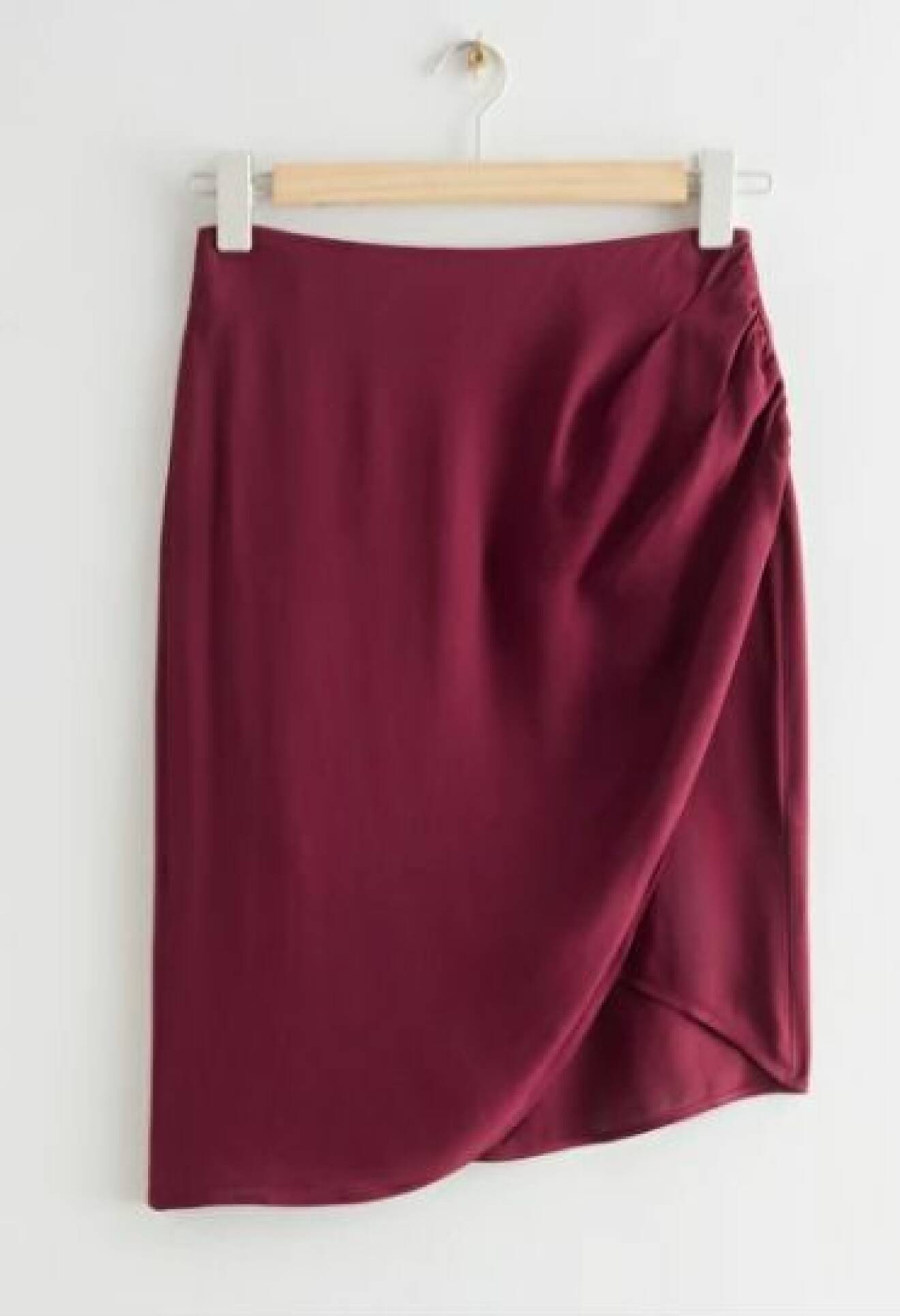 Vinröd kort kjol med drapering i ena sidan och slits. Kjol från And other stories.