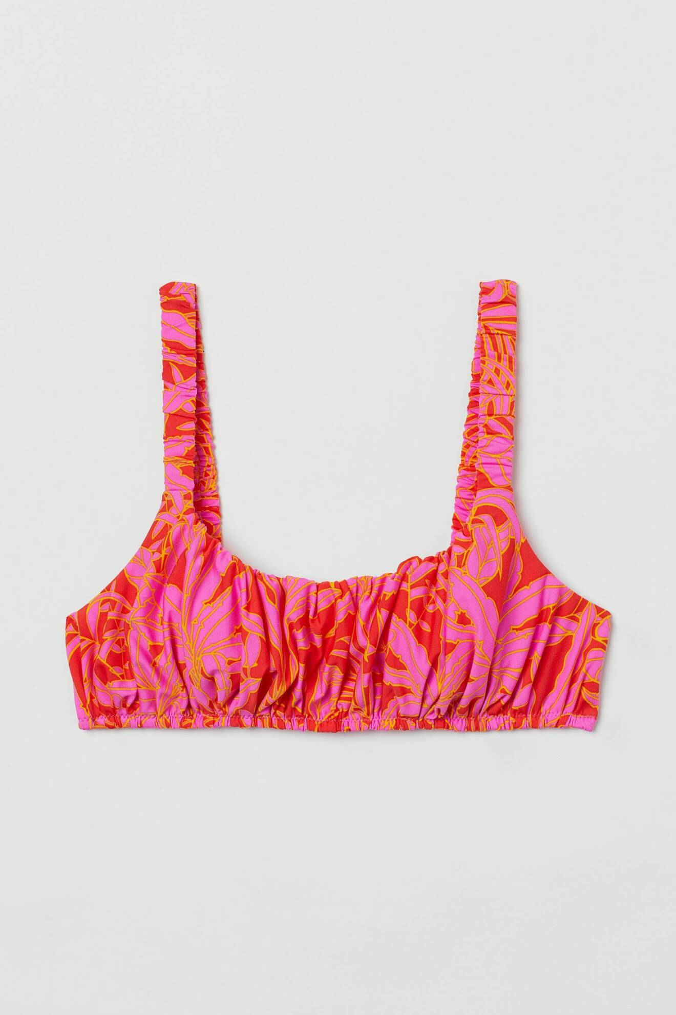 Bikinitopp med draperat och skrynkligt tyg. I tanktop-modell. Mönster i rosa, rött och orange. Bikinitopp från H&amp;M.
