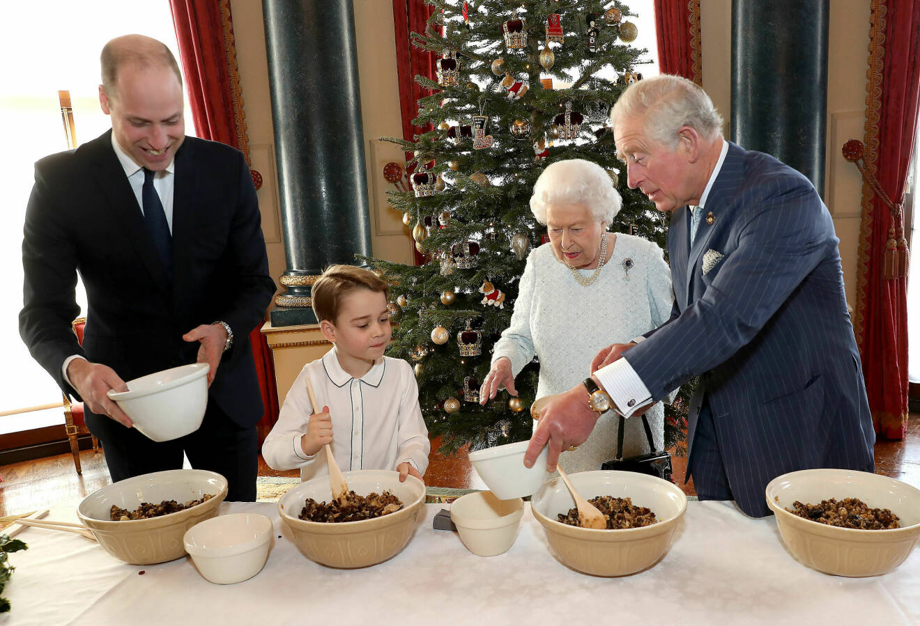 Prins Wiliam, prins George, drottning Elizabeth och prins Charles julbakar.