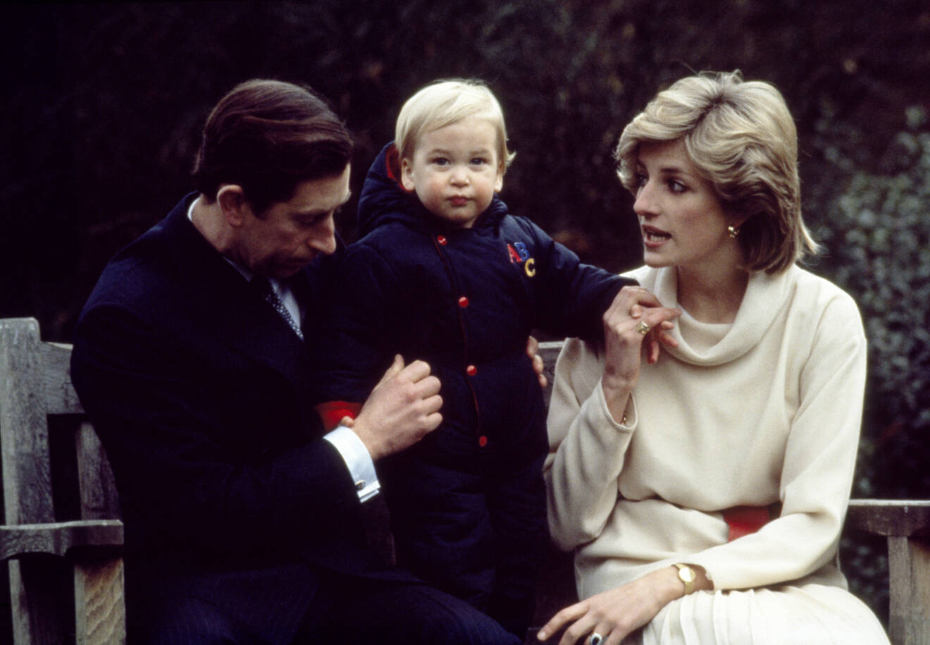 Prins Charles, prins William och Diana sitter tillsammans på en parkbänk.