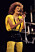 Lena Philipsson iklädd svart och gul scenklädsel under ett framträdande 1987.