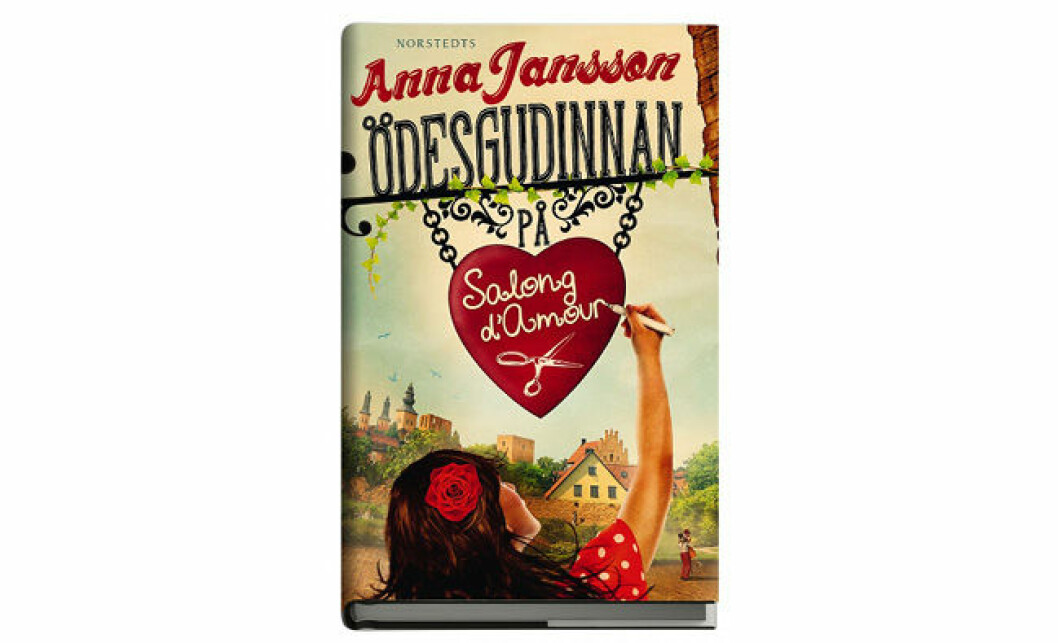 <em>Ödesgudinnan på Salong d’Amour</em> av <strong>Anna Jansson</strong> Omslag boken Ödesgudinnan på Salong d’Amour av Anna Jansson