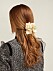 En bild på ett hårspänne i form av en hortensia från Philippa Craddocks nya kollektion på Matchesfashion.com.