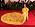 Rihanna på Met-galan 2015 i gul klänning med släp gjort av delvis rävpäls.