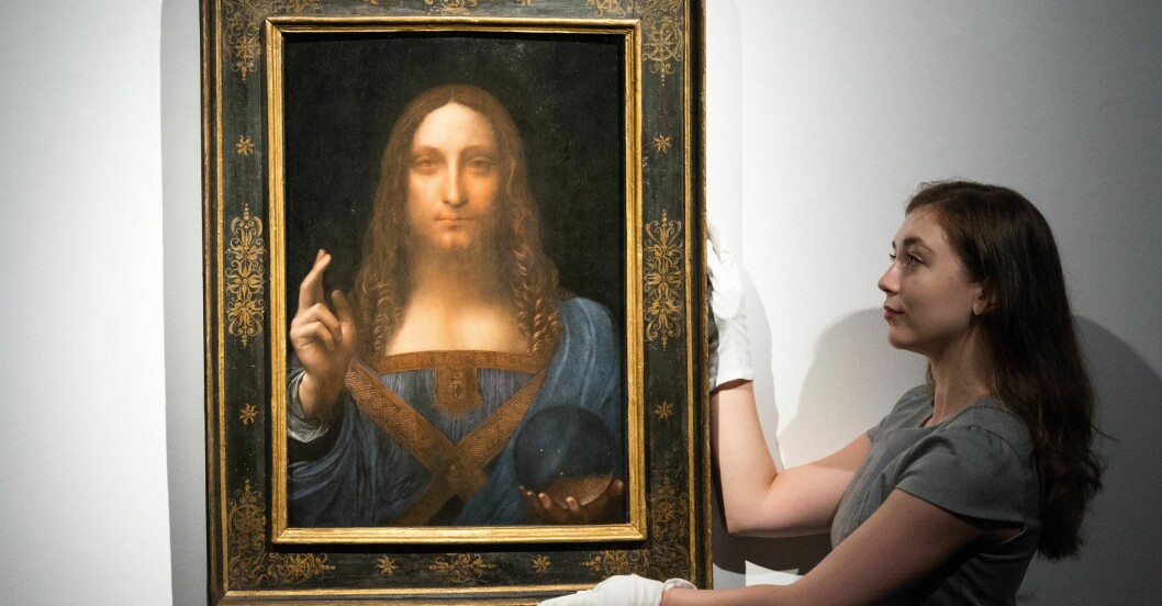 Leonardo da Vincis tavla Salvator Mundi. Leonardo da Vincis tavla Salvator Mundi hålls uppe av en kvinna.