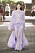 Lång, transparent ljuslila klänning med rader av volanger på längden. Svepande och vid klänning med långa ärmar. Look från Valentino ss21.